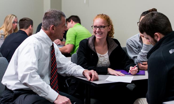 John Byrne talking with students